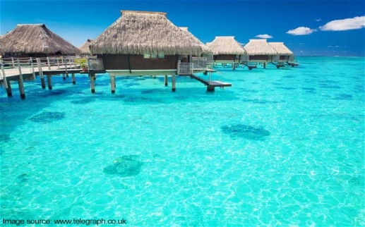 Water villas in the ocean with steps into turquoise lagoon